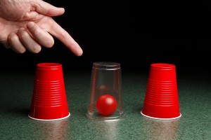 Red Ball Under Clear Cup with Hand